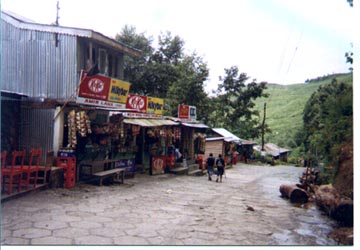 Scene on mountain road between Darjeeling and Kalimpong of a roadside stand with a KitKat shop